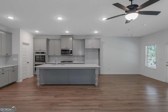 420 Tavistock Ct, Mcdonough, GA 30252 - kitchen featuring gray cabinetry, appliances with stainless steel finishes, light wood-style flooring, and recessed lighting