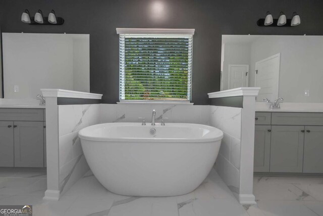 420 Tavistock Ct, Mcdonough, GA 30252 - full bath with marble finish floors, two vanities, a soaking tub, and tile walls