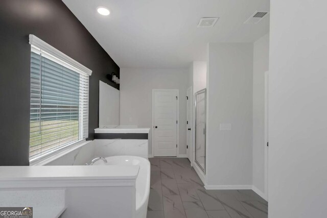 420 Tavistock Ct, Mcdonough, GA 30252 - bathroom with marble finish floors, a freestanding bath, a stall shower, and recessed lighting
