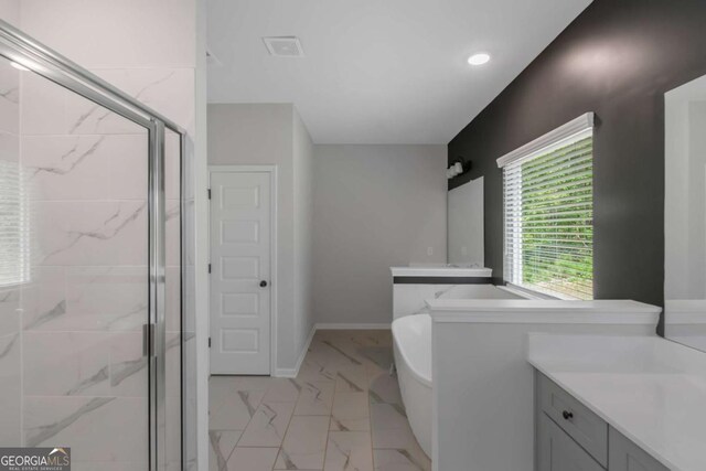 420 Tavistock Ct, Mcdonough, GA 30252 - full bath featuring vanity, a shower stall, a freestanding tub, marble finish floors, and recessed lighting