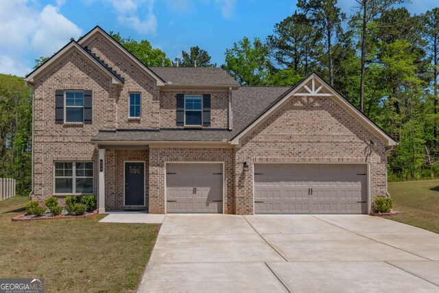 420 Tavistock Ct, Mcdonough, GA 30252 - view of front facade featuring driveway, a front yard, brick siding, and a shingled roof