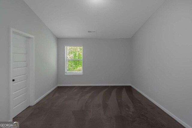 420 Tavistock Ct, Mcdonough, GA 30252 - spare room featuring baseboards and dark colored carpet