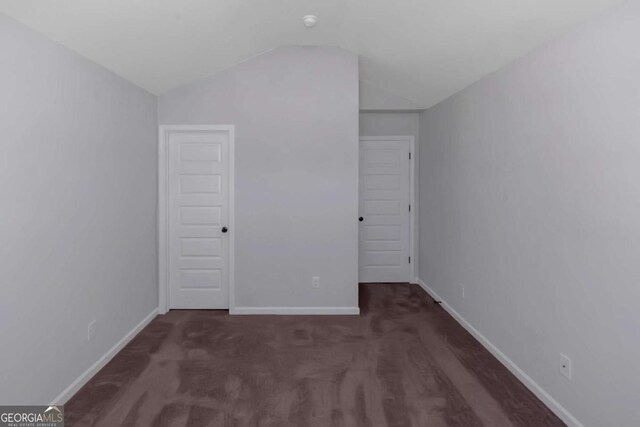420 Tavistock Ct, Mcdonough, GA 30252 - unfurnished bedroom featuring vaulted ceiling, baseboards, and carpet floors