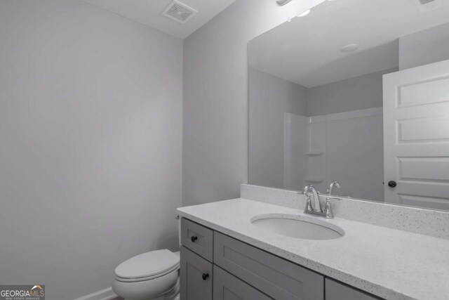 420 Tavistock Ct, Mcdonough, GA 30252 - bathroom with vanity, toilet, and a shower