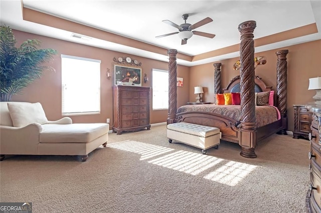 1152 Werre Way, Locust Grove, GA 30248 - bedroom featuring carpet floors, a tray ceiling, and a ceiling fan