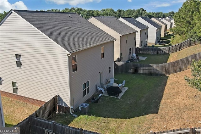 1152 Werre Way, Locust Grove, GA 30248 - view of property exterior with a patio area, central AC unit, and roof with shingles