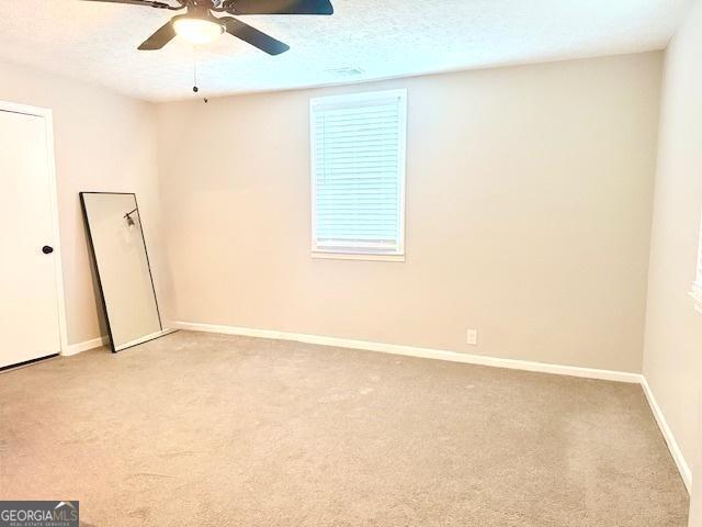 219 Broad St, Carrollton, GA 30117 - spare room with ceiling fan and light carpet