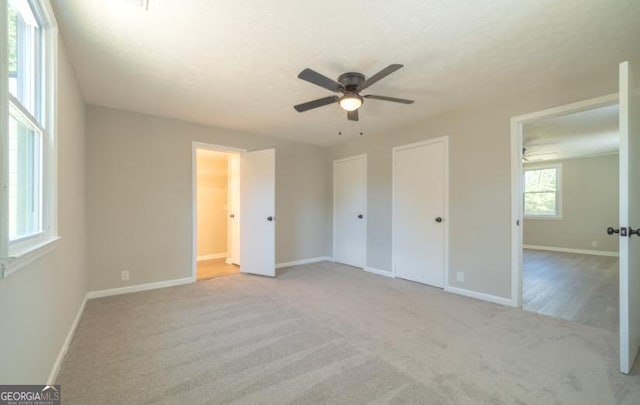 219 Broad St, Carrollton, GA 30117 - unfurnished bedroom featuring carpet flooring, multiple closets, and ceiling fan