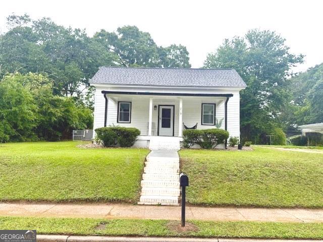 219 Broad St, Carrollton, GA 30117 - bungalow featuring a porch and a front lawn