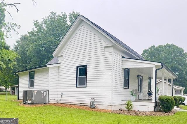 219 Broad St, Carrollton, GA 30117 - view of property exterior featuring a porch and a lawn