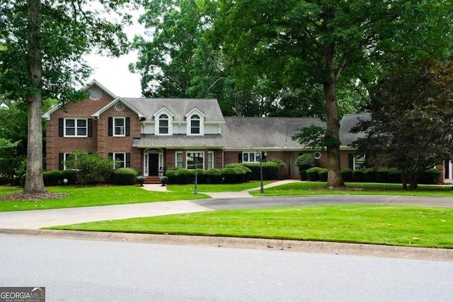 1101 Forrest Hills Dr, Watkinsville, GA 30677 - view of front facade featuring curved driveway, a front yard, and brick siding
