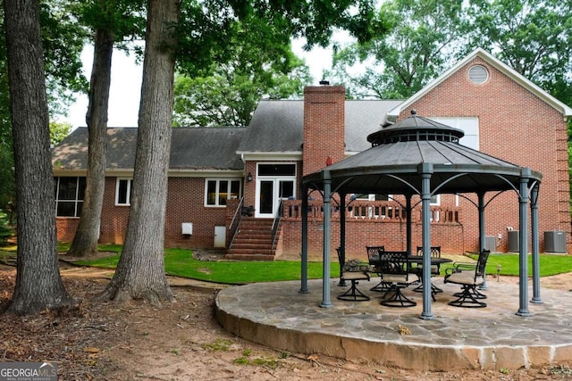 1101 Forrest Hills Dr, Watkinsville, GA 30677 - back of house featuring a gazebo, brick siding, a chimney, a patio, and a shingled roof