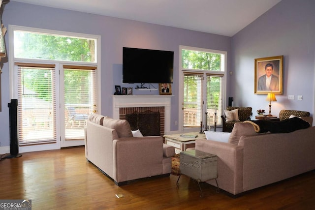 1101 Forrest Hills Dr, Watkinsville, GA 30677 - living area with a brick fireplace, healthy amount of natural light, wood finished floors, and lofted ceiling