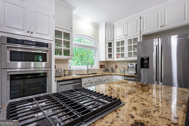 3010 White Oak Ct, Lagrange, GA 30240 - kitchen featuring stainless steel appliances, white cabinetry, ornamental molding, glass insert cabinets, and backsplash