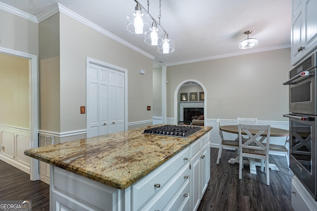 3010 White Oak Ct, Lagrange, GA 30240 - kitchen featuring appliances with stainless steel finishes, dark wood-type flooring, a fireplace, crown molding, and white cabinets