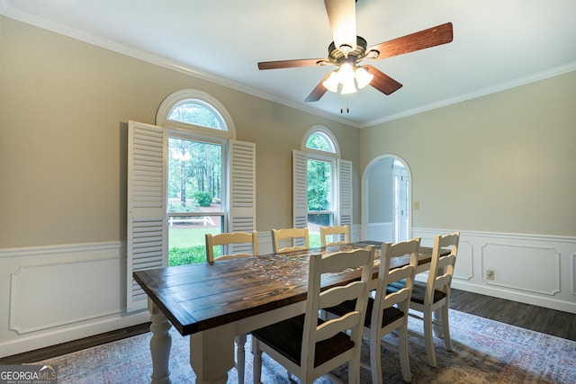 3010 White Oak Ct, Lagrange, GA 30240 - dining area featuring crown molding, dark wood-style floors, a wainscoted wall, a ceiling fan, and arched walkways