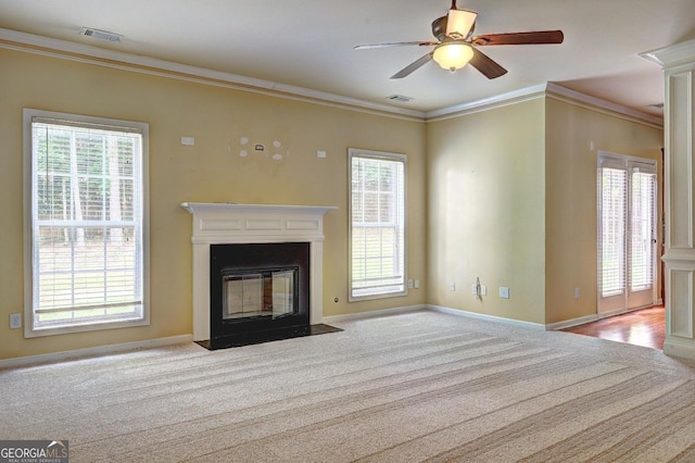 1132 Hargrove Ct, Locust Grove, GA 30248 - unfurnished living room with carpet, a fireplace with flush hearth, plenty of natural light, crown molding, and a ceiling fan
