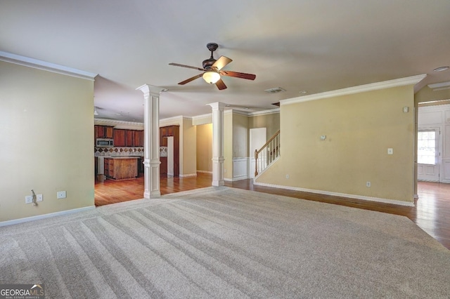 1132 Hargrove Ct, Locust Grove, GA 30248 - unfurnished living room featuring ornate columns, crown molding, ceiling fan, stairs, and wood finished floors