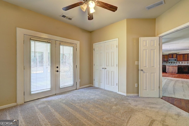 1132 Hargrove Ct, Locust Grove, GA 30248 - unfurnished bedroom with french doors, access to exterior, carpet, and ceiling fan