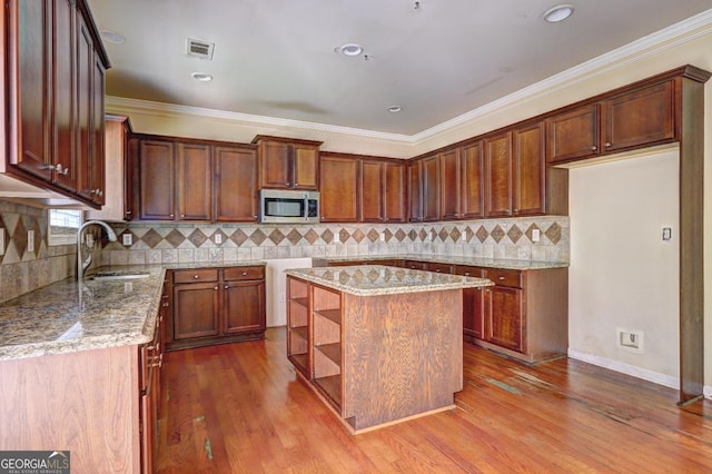 1132 Hargrove Ct, Locust Grove, GA 30248 - kitchen featuring stainless steel microwave, backsplash, light stone countertops, open shelves, and dark wood-style floors