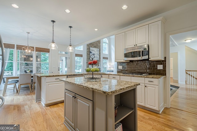 4096 Vinings Mill Trl SE, Smyrna, GA 30080 - kitchen featuring appliances with stainless steel finishes, a center island, plenty of natural light, light wood-style floors, and recessed lighting