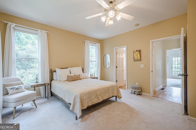 4096 Vinings Mill Trl SE, Smyrna, GA 30080 - bedroom featuring multiple windows, light carpet, baseboards, and ceiling fan