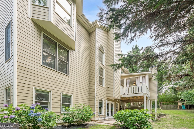 4096 Vinings Mill Trl SE, Smyrna, GA 30080 - back of house featuring a balcony, a playground, a patio, and a lawn