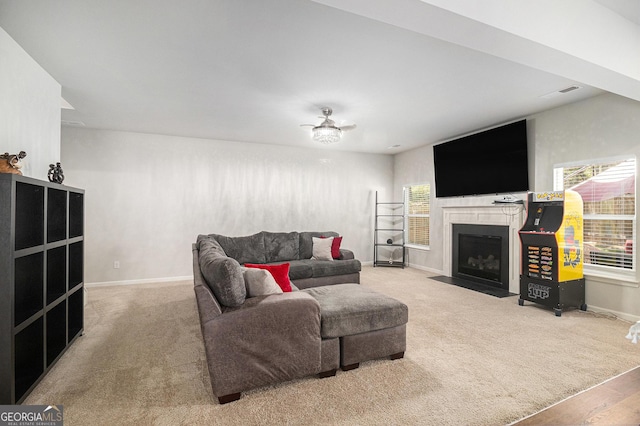 210 Kestrel Cir, Covington, GA 30014 - carpeted living area featuring plenty of natural light, a fireplace with flush hearth, and a ceiling fan
