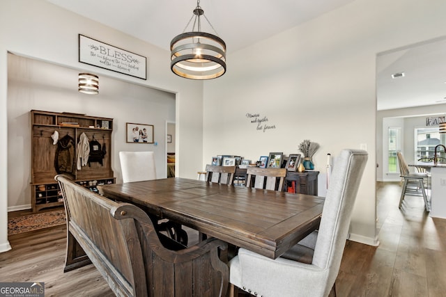 102 Olson Way, Kingsland, GA 31548 - dining room featuring a chandelier, wood finished floors, and baseboards