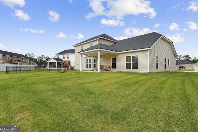102 Olson Way, Kingsland, GA 31548 - rear view of house with a playground, a patio, and a shingled roof