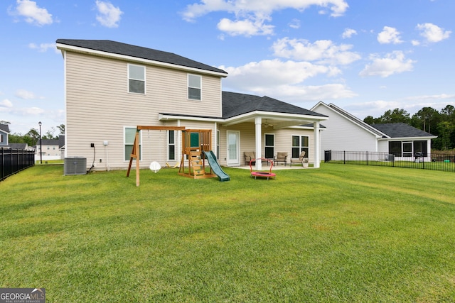 102 Olson Way, Kingsland, GA 31548 - back of property featuring a playground, central AC, and a patio