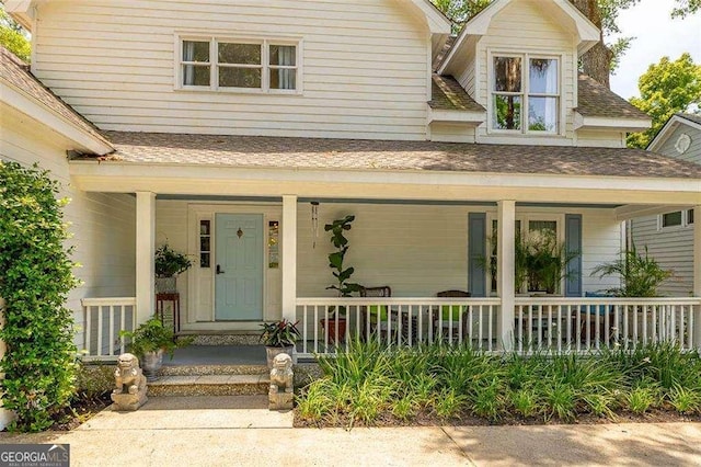 107 Newfield St, Saint Simons, GA 31522 - view of front of house with covered porch and roof with shingles
