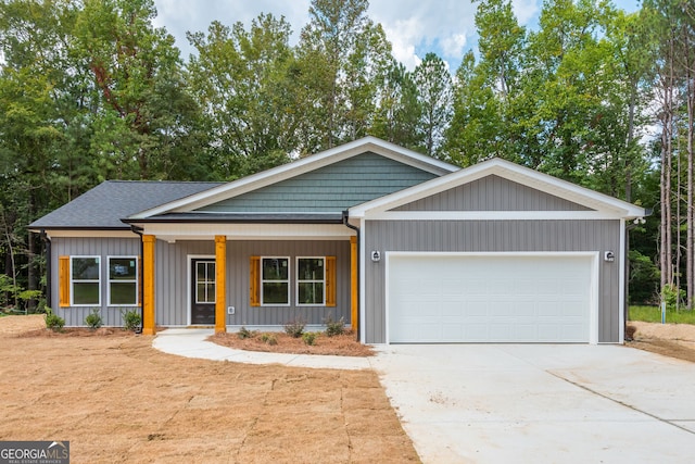 246 Stephens Rd, Cedartown, GA 30125 - view of front facade featuring concrete driveway, a garage, covered porch, and roof with shingles