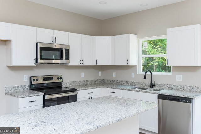 246 Stephens Rd, Cedartown, GA 30125 - kitchen featuring stainless steel appliances, white cabinets, and light stone countertops