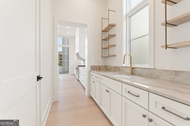260 Guild Ln, Fayetteville, GA 30214 - kitchen with open shelves, light wood-type flooring, white cabinets, light stone countertops, and recessed lighting