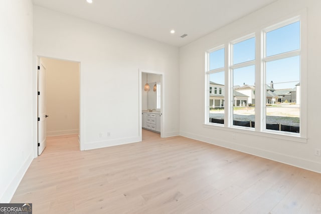260 Guild Ln, Fayetteville, GA 30214 - unfurnished bedroom with light wood-style floors, recessed lighting, a walk in closet, and ensuite bath