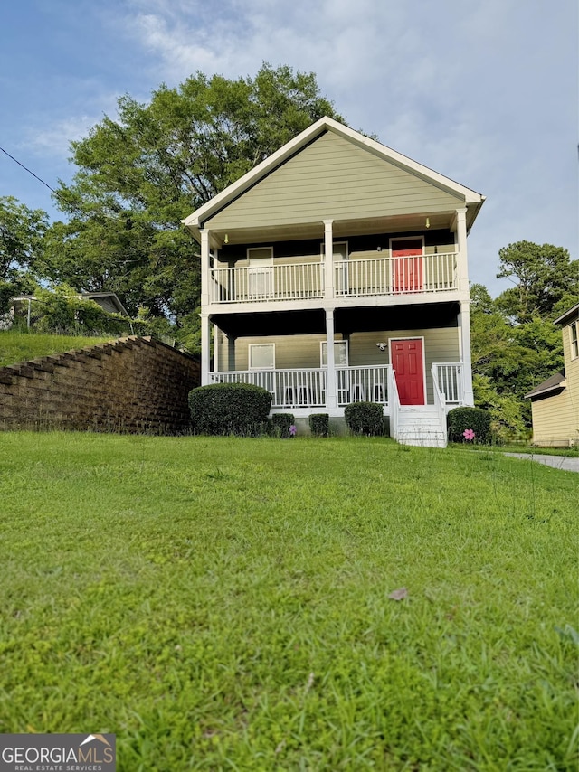 2650 Batavia St, East Point, GA 30344 - view of front of house with covered porch, a balcony, and a front yard
