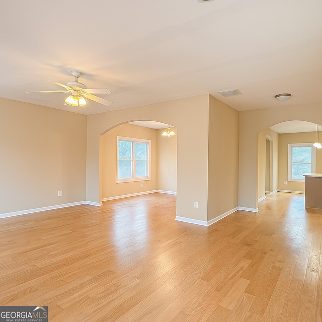 2650 Batavia St, East Point, GA 30344 - empty room featuring arched walkways, healthy amount of natural light, light wood-style floors, and ceiling fan