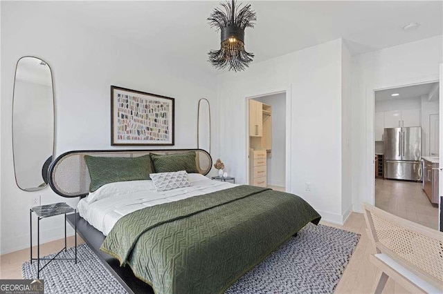 775 Juniper St NE Unit 111, Atlanta, GA 30308 - bedroom with freestanding refrigerator and light wood-style floors