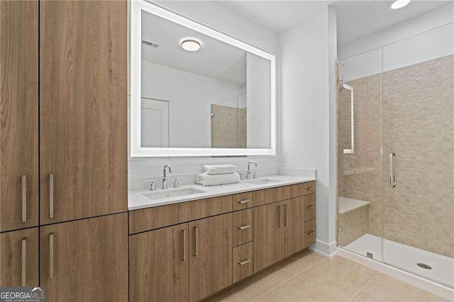 775 Juniper St NE Unit 111, Atlanta, GA 30308 - bathroom featuring double vanity, a shower stall, and tile patterned floors