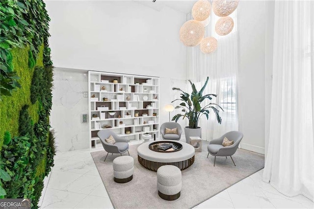 775 Juniper St NE Unit 111, Atlanta, GA 30308 - sitting room with marble look tile flooring and a towering ceiling