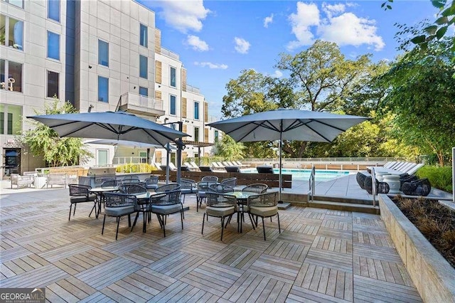 775 Juniper St NE Unit 111, Atlanta, GA 30308 - view of patio / terrace with outdoor dining area and an outdoor pool