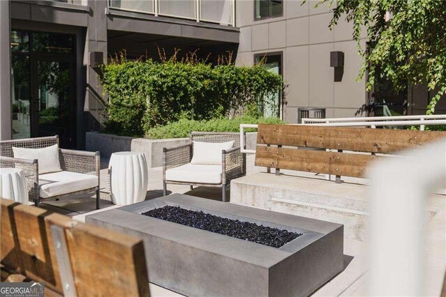 775 Juniper St NE Unit 111, Atlanta, GA 30308 - view of patio with an outdoor living space with a fire pit