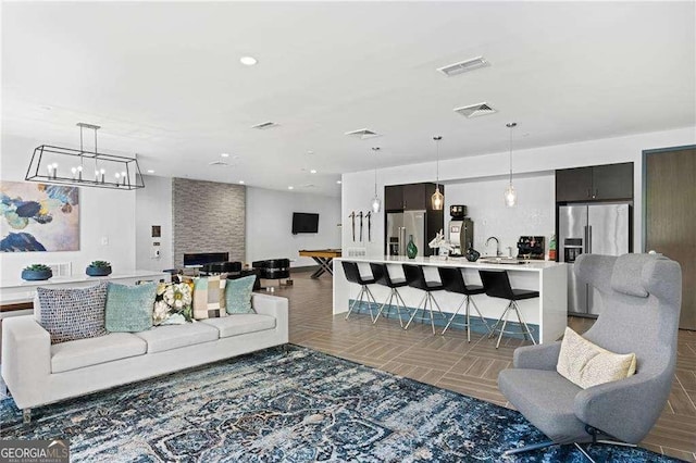 775 Juniper St NE Unit 111, Atlanta, GA 30308 - living area featuring a chandelier and recessed lighting