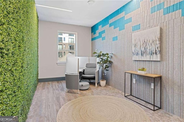 775 Juniper St NE Unit 111, Atlanta, GA 30308 - living area featuring an accent wall and wood finished floors