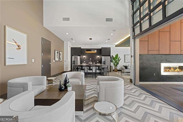 775 Juniper St NE Unit 111, Atlanta, GA 30308 - living room with a warm lit fireplace, a towering ceiling, and recessed lighting