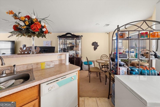 1955 Shawn Wayne Cir SE, Atlanta, GA 30316 - kitchen featuring dishwasher, light countertops, light tile patterned flooring, and light carpet