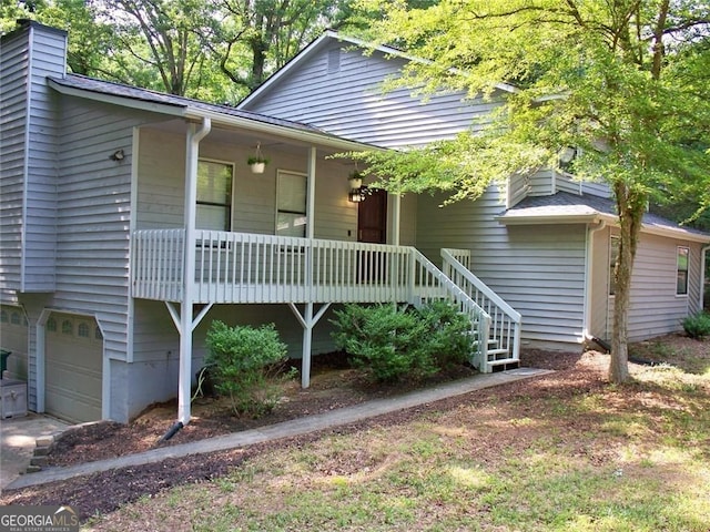 219 Park Ave, Woodstock, GA 30188 - view of front of house with a porch, a garage, and a chimney