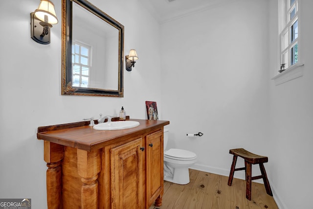 2216 Trammel Rd, Cumming, GA 30041 - half bath with plenty of natural light, wood finished floors, vanity, and ornamental molding