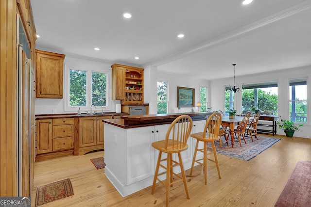 2216 Trammel Rd, Cumming, GA 30041 - kitchen with dark countertops, dishwasher, healthy amount of natural light, a breakfast bar, and recessed lighting